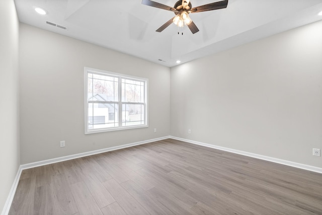 empty room featuring ceiling fan and hardwood / wood-style floors