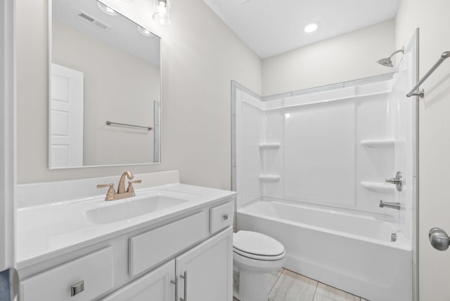 full bathroom featuring bathing tub / shower combination, vanity, and toilet