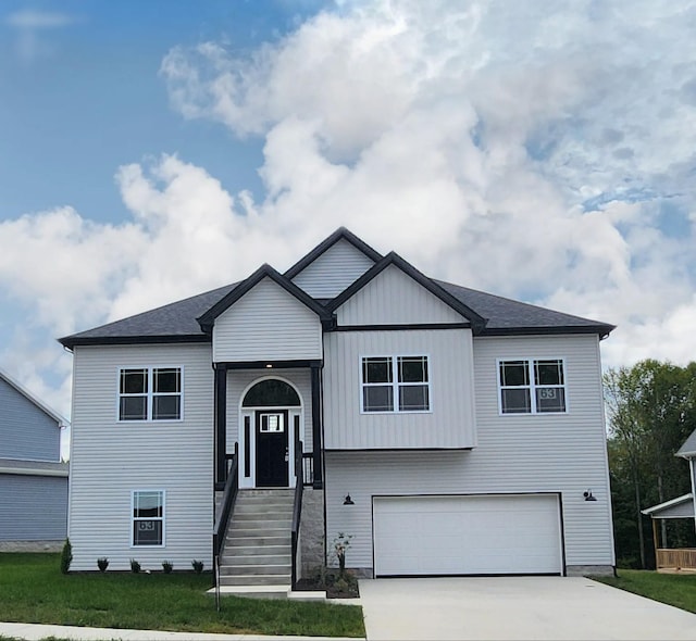 view of front of home with a garage and a front lawn