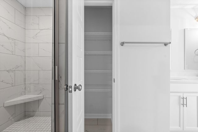 bathroom with a shower with door