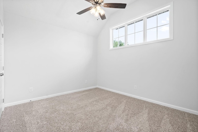 unfurnished room featuring carpet flooring, vaulted ceiling, and ceiling fan