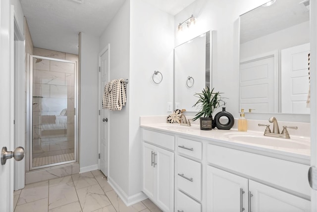 bathroom featuring a textured ceiling, vanity, and walk in shower