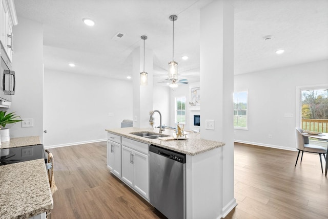 kitchen featuring hanging light fixtures, sink, white cabinets, and stainless steel dishwasher