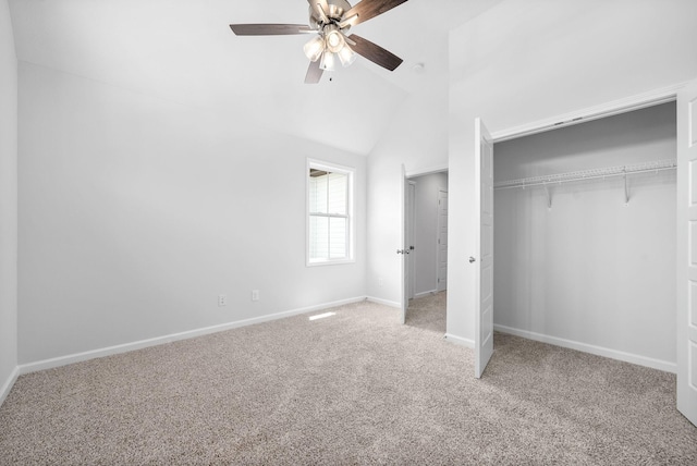 unfurnished bedroom featuring ceiling fan, carpet floors, high vaulted ceiling, and a closet