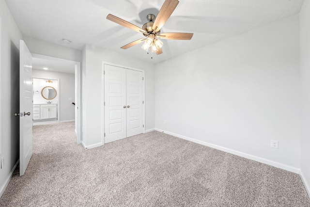 unfurnished bedroom featuring carpet flooring, ceiling fan, and a closet