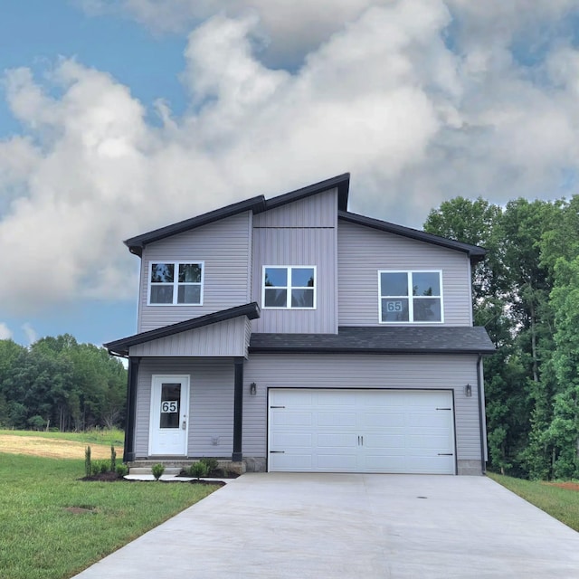 view of front of property with a garage and a front lawn