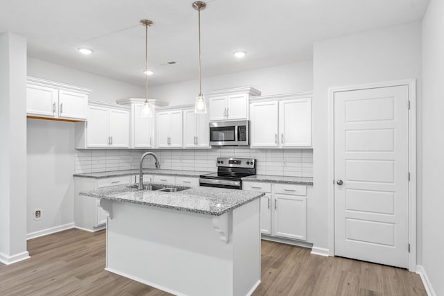 kitchen with a kitchen island with sink, sink, white cabinets, and stainless steel appliances