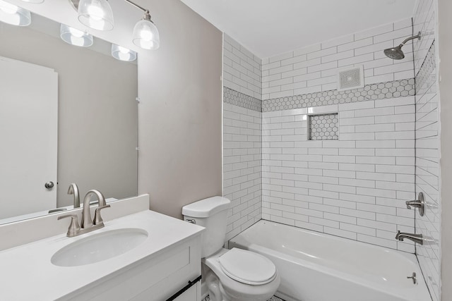 full bathroom featuring tiled shower / bath combo, toilet, and vanity