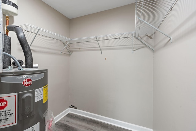 interior space with water heater and hardwood / wood-style flooring