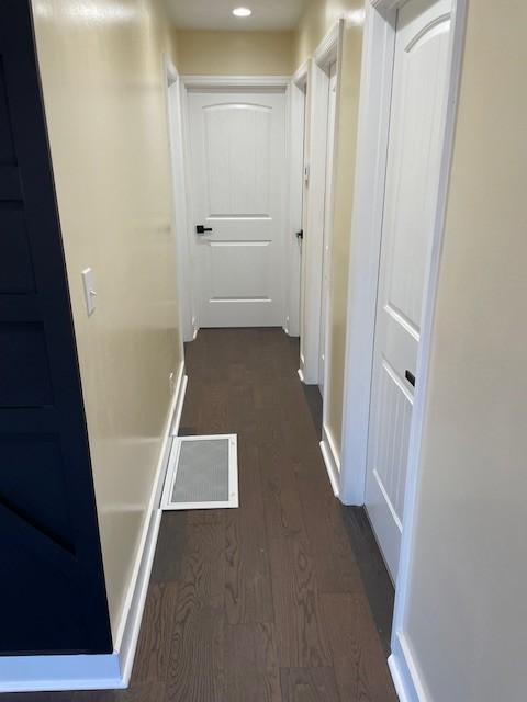 hallway with dark hardwood / wood-style flooring