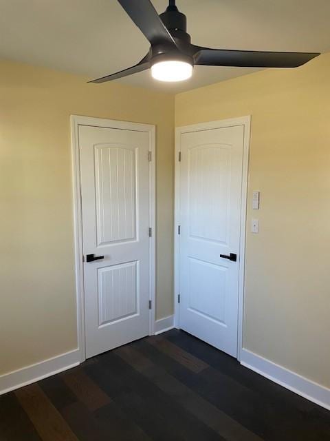 unfurnished bedroom featuring dark hardwood / wood-style floors and ceiling fan