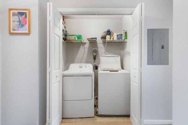 laundry room with electric panel and independent washer and dryer