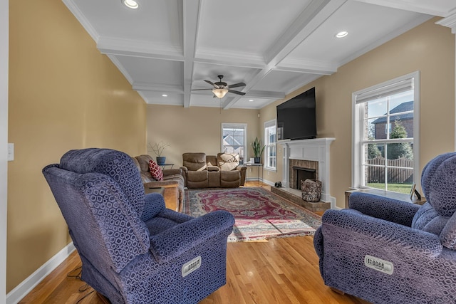 living room featuring beamed ceiling, wood-type flooring, ceiling fan, and coffered ceiling