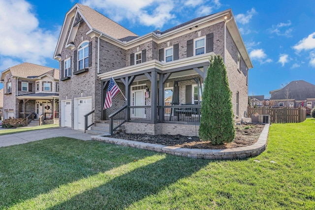 view of front of home with a garage, covered porch, and a front yard