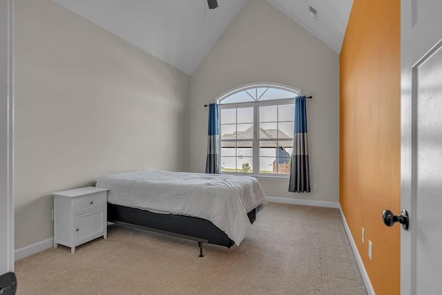 bedroom featuring ceiling fan, light colored carpet, and high vaulted ceiling