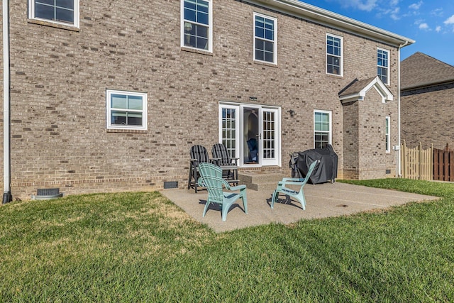 rear view of property featuring a patio area and a lawn