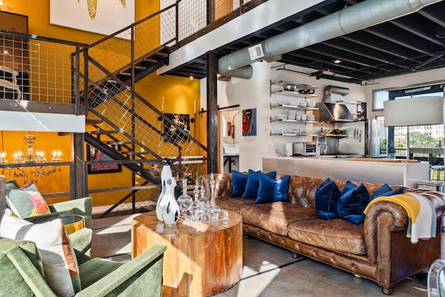 living room featuring concrete floors and a high ceiling