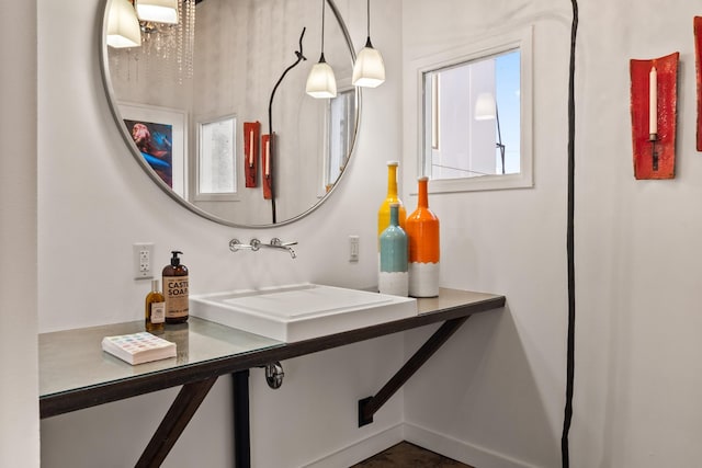 bathroom with sink and a chandelier