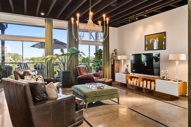 living room with concrete floors and an inviting chandelier