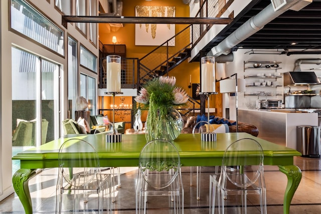 dining space with a towering ceiling