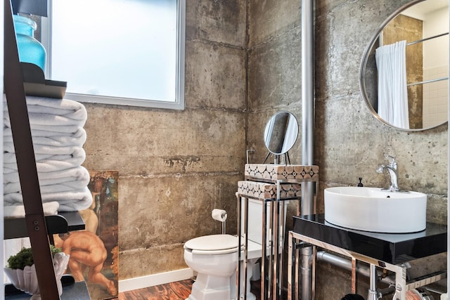 bathroom featuring a shower with shower curtain, wood-type flooring, toilet, and sink