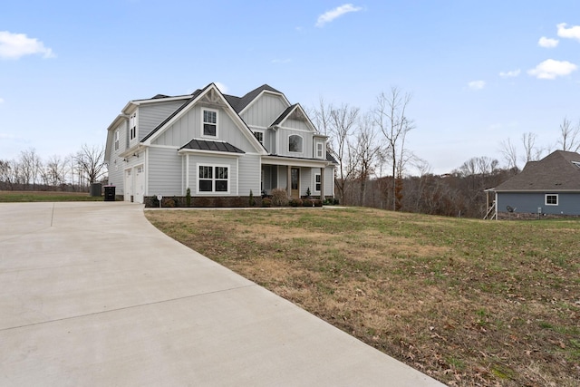 craftsman house with covered porch, a front yard, and a garage