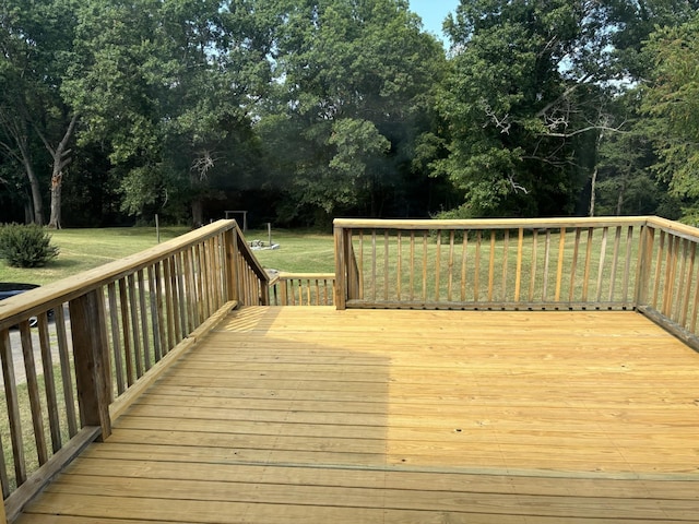 wooden terrace featuring a yard