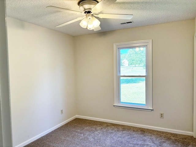 carpeted empty room with ceiling fan and a textured ceiling