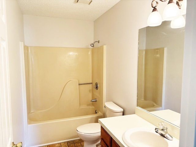 full bathroom with vanity, toilet, washtub / shower combination, and a textured ceiling