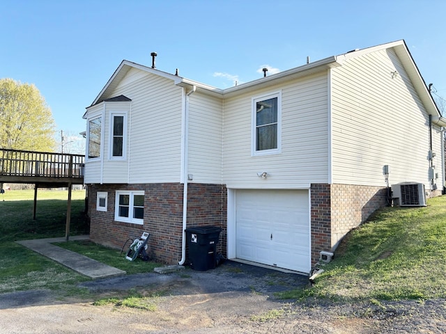 back of property with cooling unit, a garage, and a deck