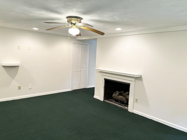 unfurnished living room with dark carpet and ceiling fan