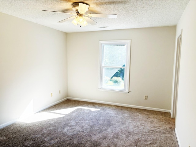 empty room with a textured ceiling and carpet floors