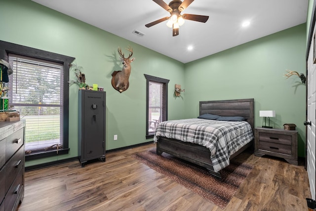 bedroom with ceiling fan and dark hardwood / wood-style flooring