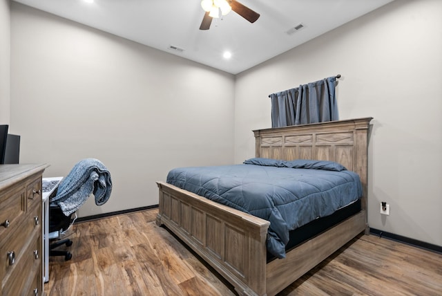 bedroom with ceiling fan and wood-type flooring