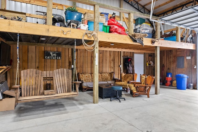 interior space featuring wood walls, electric panel, and concrete floors