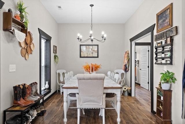 dining room featuring a wealth of natural light, dark hardwood / wood-style flooring, and a chandelier