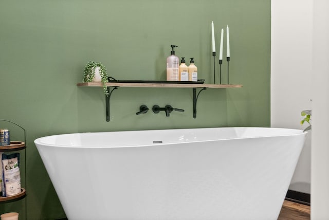 bathroom featuring hardwood / wood-style floors and a bath