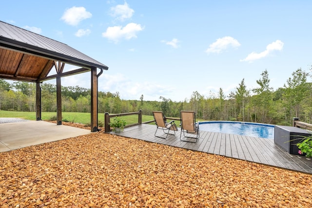 view of swimming pool with a deck and a patio area