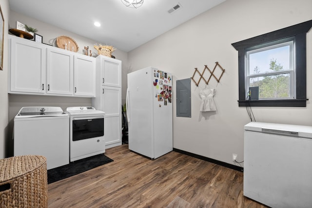 laundry room with dark hardwood / wood-style flooring, cabinets, independent washer and dryer, and electric panel