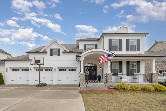 view of front of property with a front lawn, a porch, and a garage