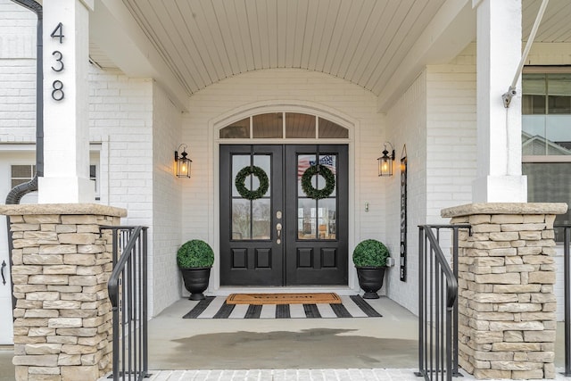 view of exterior entry featuring french doors