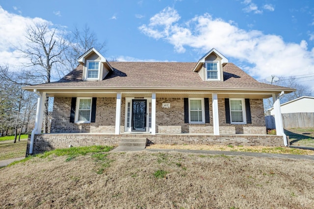 new england style home featuring covered porch