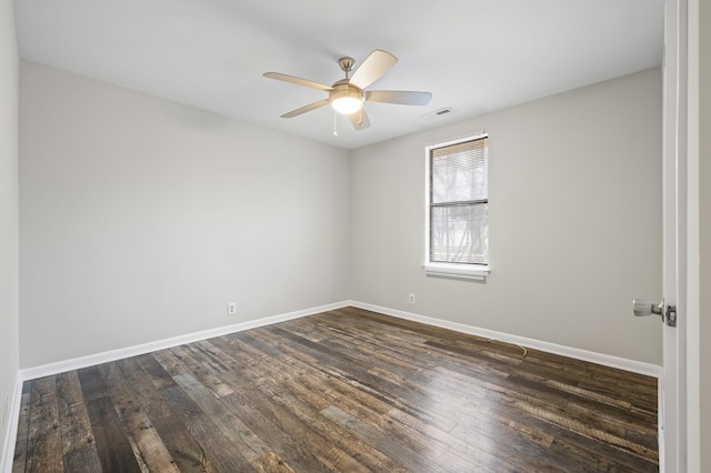 empty room with dark hardwood / wood-style floors and ceiling fan