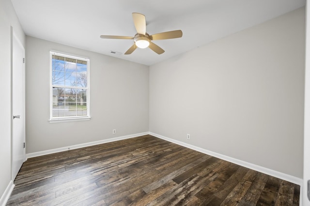 unfurnished room with ceiling fan and dark wood-type flooring