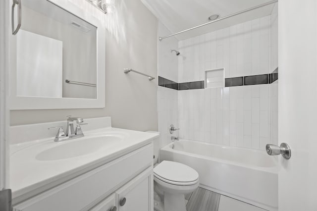 full bathroom featuring vanity, toilet, and tiled shower / bath combo