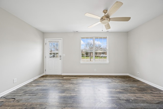 empty room featuring ceiling fan and dark wood-type flooring