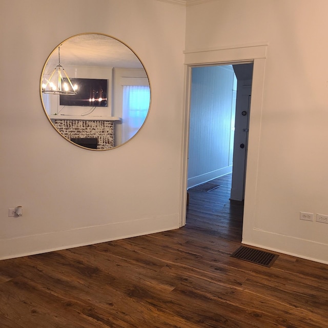 interior space featuring dark hardwood / wood-style flooring and a chandelier