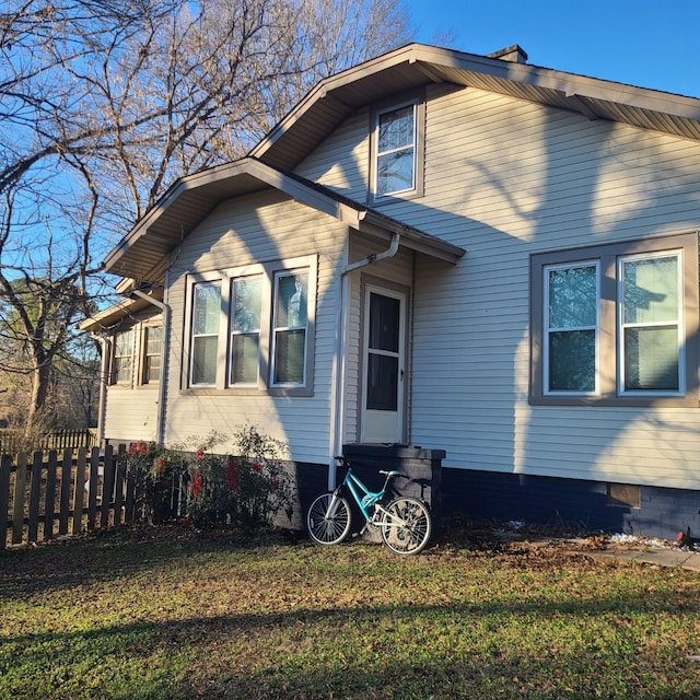 view of side of property with a yard