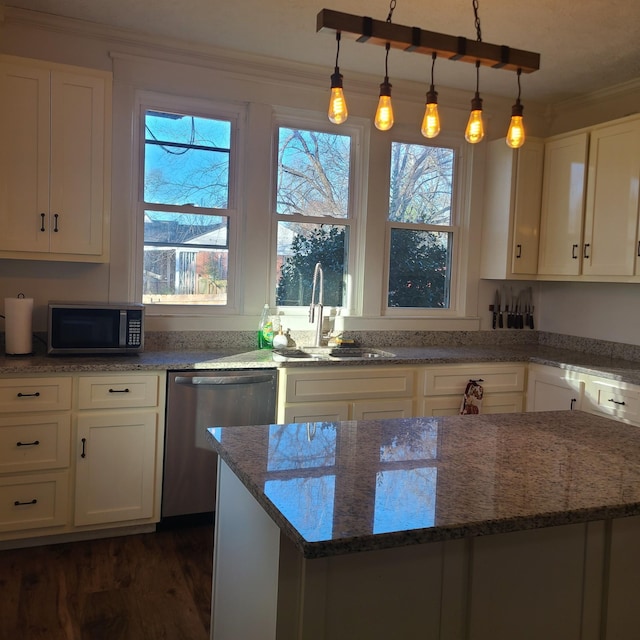 kitchen with stone counters, white cabinets, sink, ornamental molding, and stainless steel appliances