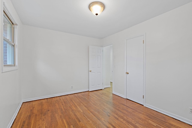 empty room with hardwood / wood-style floors